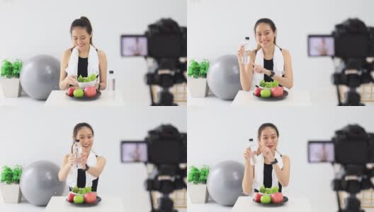 美丽的亚洲女人健康的博主展示了苹果水果和干净的减肥食品。在摄像机前录制在家的视频直播。在线社交媒体上的健身影响者。高清在线视频素材下载