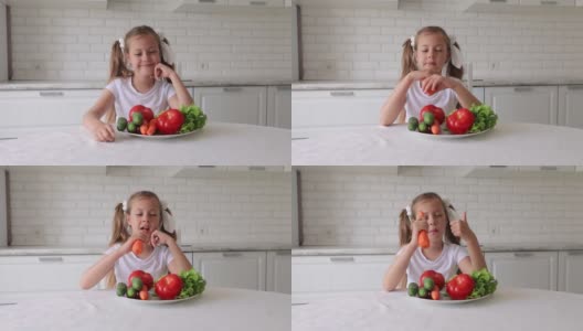 孩子们喜欢吃水果和蔬菜。小女孩吃蔬菜高清在线视频素材下载