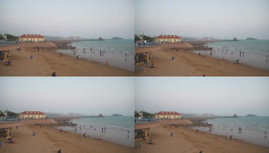 日落天空青岛海岸线著名的拥挤公共海滩全景4k中国高清在线视频素材下载