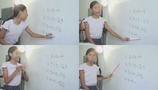 快乐的亚洲女孩教数学科目为她的妹妹在白板上在家上学，呆在家里的概念。高清在线视频素材下载