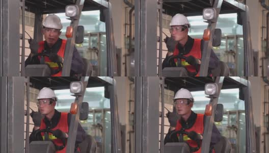 亚洲男性仓库工人在重工业制造工厂驾驶叉车与同事通过无线电话或对讲机交谈。男人努力工作的肖像。船舶交付产品高清在线视频素材下载