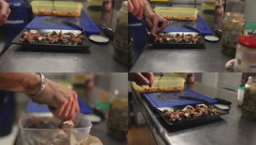 专业厨师将鱿鱼和沙丁鱼放在盘子里高清在线视频素材下载