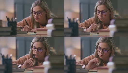 一个年轻女子一边学习一边做笔记的4k视频高清在线视频素材下载