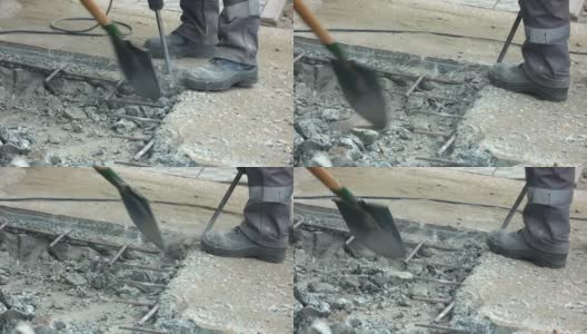 一个工人在夏天用手提钻修理路面。公路上正在施工高清在线视频素材下载