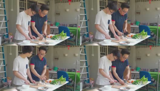 周末的时候，亚洲华人父亲和儿子在自家后院的厨房做饭，为家人准备晚餐高清在线视频素材下载
