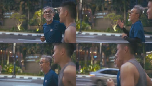 侧观亚洲华人活跃的老人和他的儿子晚上下班后一起在城市跑步慢跑高清在线视频素材下载