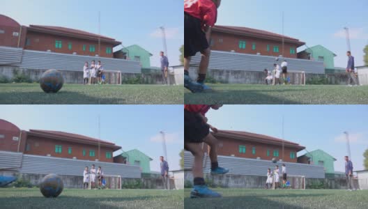 男孩足球运动员向球门踢球的慢动作高清在线视频素材下载