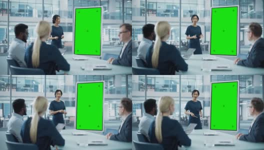 女运营经理为一组经济学家做会议报告。亚洲妇女使用数字白板与垂直绿色屏幕模拟显示。在商务办公室工作的人。高清在线视频素材下载