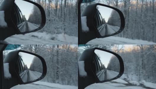 侧视镜反射冬季森林道路。风景与空荡的公路穿过白雪森林。汽车在道路上超速行驶。汽车在运动。旅游、旅游、旅行的概念。冰雪覆盖的树木。高清在线视频素材下载