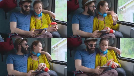 一对夫妇在火车上用平板电脑上网高清在线视频素材下载