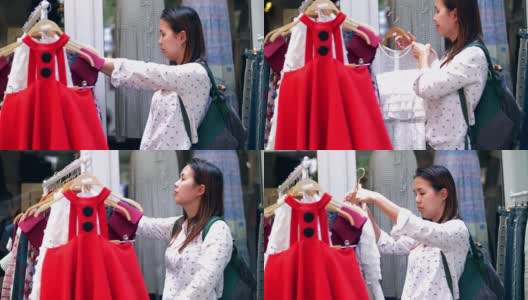 年轻美丽的亚洲女人在服装店购物衣服高清在线视频素材下载