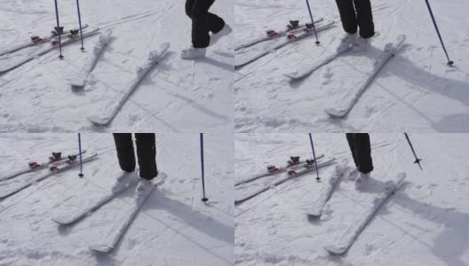 一个滑雪者穿着白色滑雪靴穿上他的下坡滑雪板高清在线视频素材下载