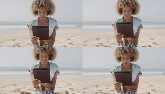 非裔美国女孩在海滩上使用平板电脑高清在线视频素材下载
