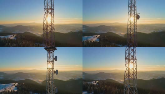 在山上飞过无线电塔，冰雪覆盖的冬季景观高清在线视频素材下载