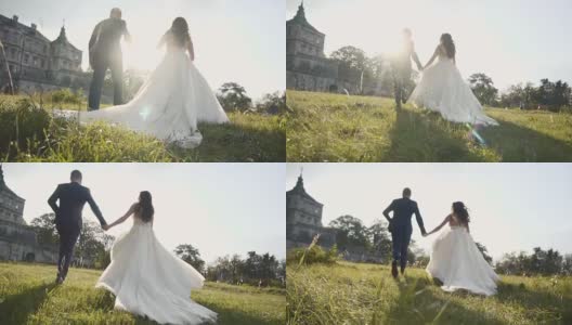 在日落城堡附近的草地上奔跑的新婚夫妇高清在线视频素材下载