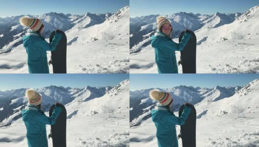 女滑雪板运动员看着滑雪坡高清在线视频素材下载