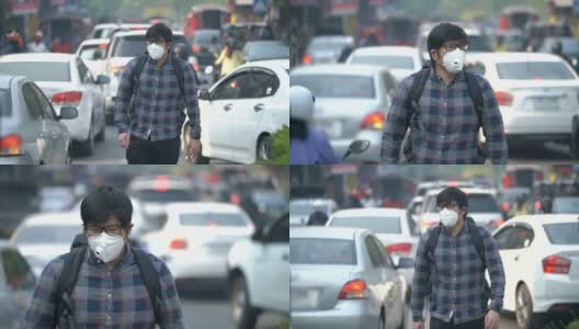一名亚洲男子戴着口罩在交通中行走高清在线视频素材下载