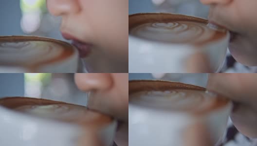 女人喝咖啡和拿铁艺术的特写，慢镜头高清在线视频素材下载