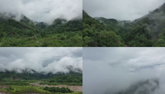 自然组成的森林和绿色山脉混合云塔克，老挝，亚洲，在雨季，无人机在一天的雨和云。高清在线视频素材下载