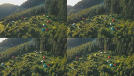 拂晓在山间，游客从帐篷中鸟瞰。在山里露营的游客。帐篷在山上扎营。徒步旅行高清在线视频素材下载