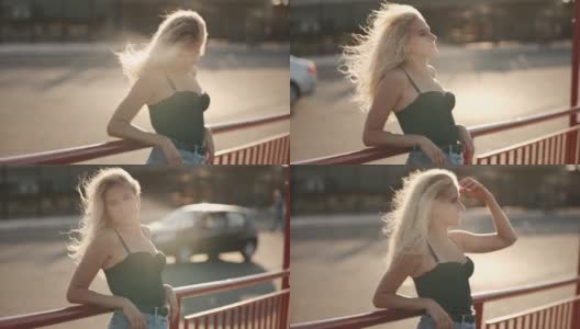 一头卷发的年轻美女走在城市的大街上，太阳在夕阳下照耀着高清在线视频素材下载