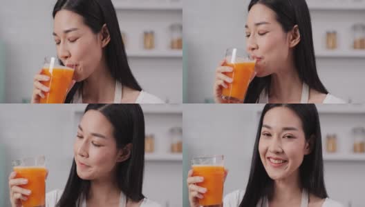 年轻的亚洲女子喝着橙汁，拿着一杯橙汁，微笑着看着镜头。高清在线视频素材下载