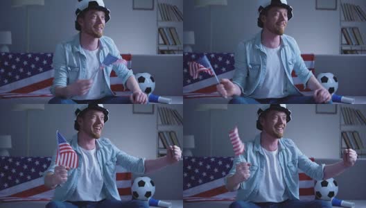 美国球迷挥舞着美国国旗，在家看电视上的足球比赛高清在线视频素材下载