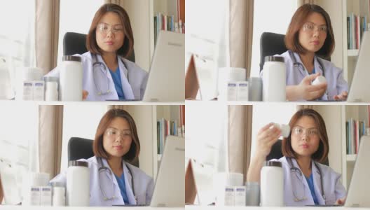 女医生用笔记本电脑检查药品并填写病历高清在线视频素材下载