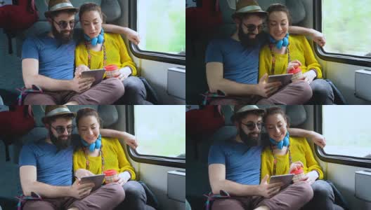 夫妇在火车上浏览平板电脑高清在线视频素材下载