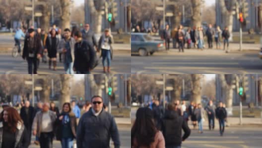 一群模糊的人在镜头前穿过马路高清在线视频素材下载