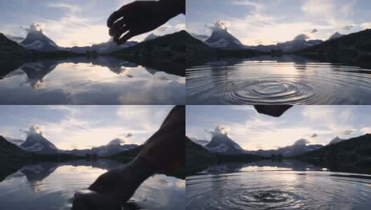 慢镜头:在马特洪峰下的山湖中，用手舀水的细节高清在线视频素材下载