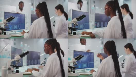 非洲和亚洲的科学家正在研究DNA样本。带有DNA序列和脑波扫描的电脑屏幕。讨论高清在线视频素材下载