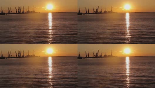 起重机在海港日落，海港附近的海港，美丽的海景，大海港日落高清在线视频素材下载