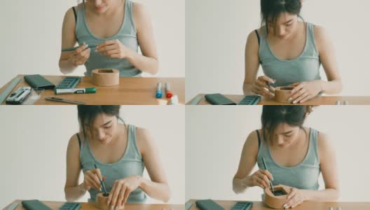 DIY:亚洲妇女使用螺丝刀高清在线视频素材下载