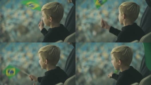 小男孩唱着歌，挥舞着巴西国旗支持巴西队高清在线视频素材下载