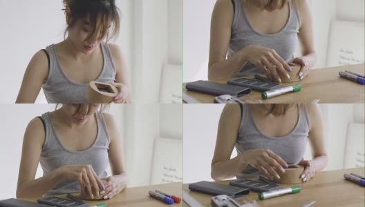 DIY:亚洲妇女用螺丝刀修理木钟高清在线视频素材下载