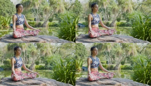 瑜伽在公园，年轻的亚洲女子在姿势坐莲花位置和冥想高清在线视频素材下载
