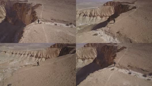 徒步旅行者在沙漠中爬山的鸟瞰图高清在线视频素材下载