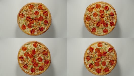 整个大披萨圈在一个白色的表面上旋转高清在线视频素材下载