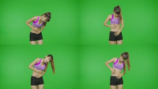 腹部肌肉极度疼痛，绿屏，锻炼，运动事故，损伤。适合年轻的亚洲体育女子穿着紫色的布在痛苦的锻炼期间在镜头前。高清在线视频素材下载