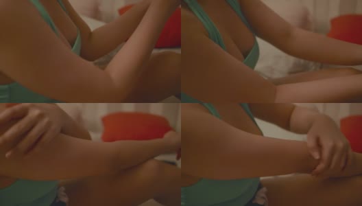 亚洲女性在床上涂抹身体乳液。高清在线视频素材下载
