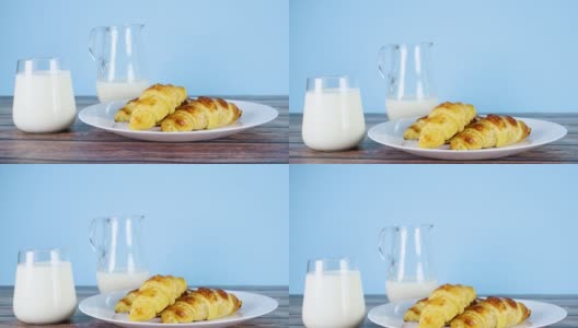 杯里的鲜牛奶和三块美味的羊角面包当早餐高清在线视频素材下载