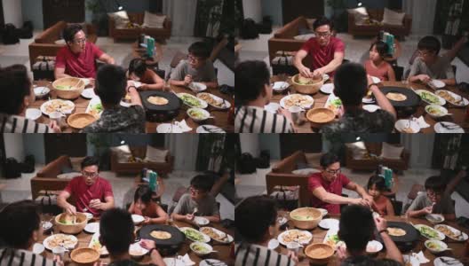 亚洲华人家庭和朋友在家里吃着传统的中国汽船菜共进晚餐高清在线视频素材下载