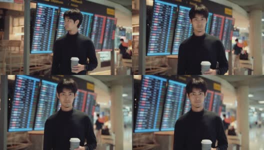 亚洲游客拿着咖啡杯站在机场候机厅高清在线视频素材下载