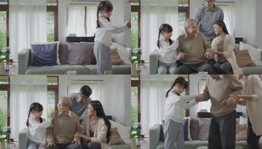 亚洲老年男爷爷坐在家中客厅的沙发沙发上进行隔离概念保健，有慢性健康问题或腰痛的退休老人与家人一起。高清在线视频素材下载