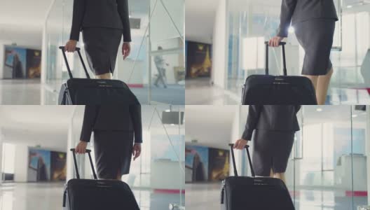 近距离观察女空乘人员拖着行李或手提箱走向机场候机楼。乘务人员职业概念。高清在线视频素材下载