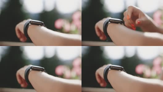 女人使用她的智能手表触摸屏可穿戴技术设备。年轻女子正在试用新款智能手表。聪明的手表。女性腕上的智能手表高清在线视频素材下载