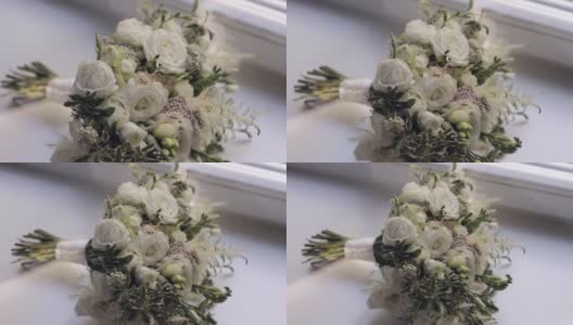 婚礼金戒指躺在美丽的婚礼白玫瑰花束在白色的窗台上高清在线视频素材下载