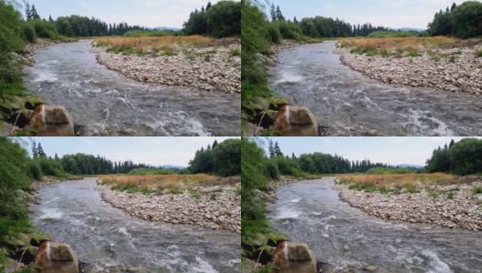 一条小河在群山的映衬下流过石头。秋天背景高清在线视频素材下载