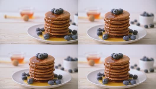 巧克力煎饼，蓝莓和蜂蜜放在盘子里高清在线视频素材下载
